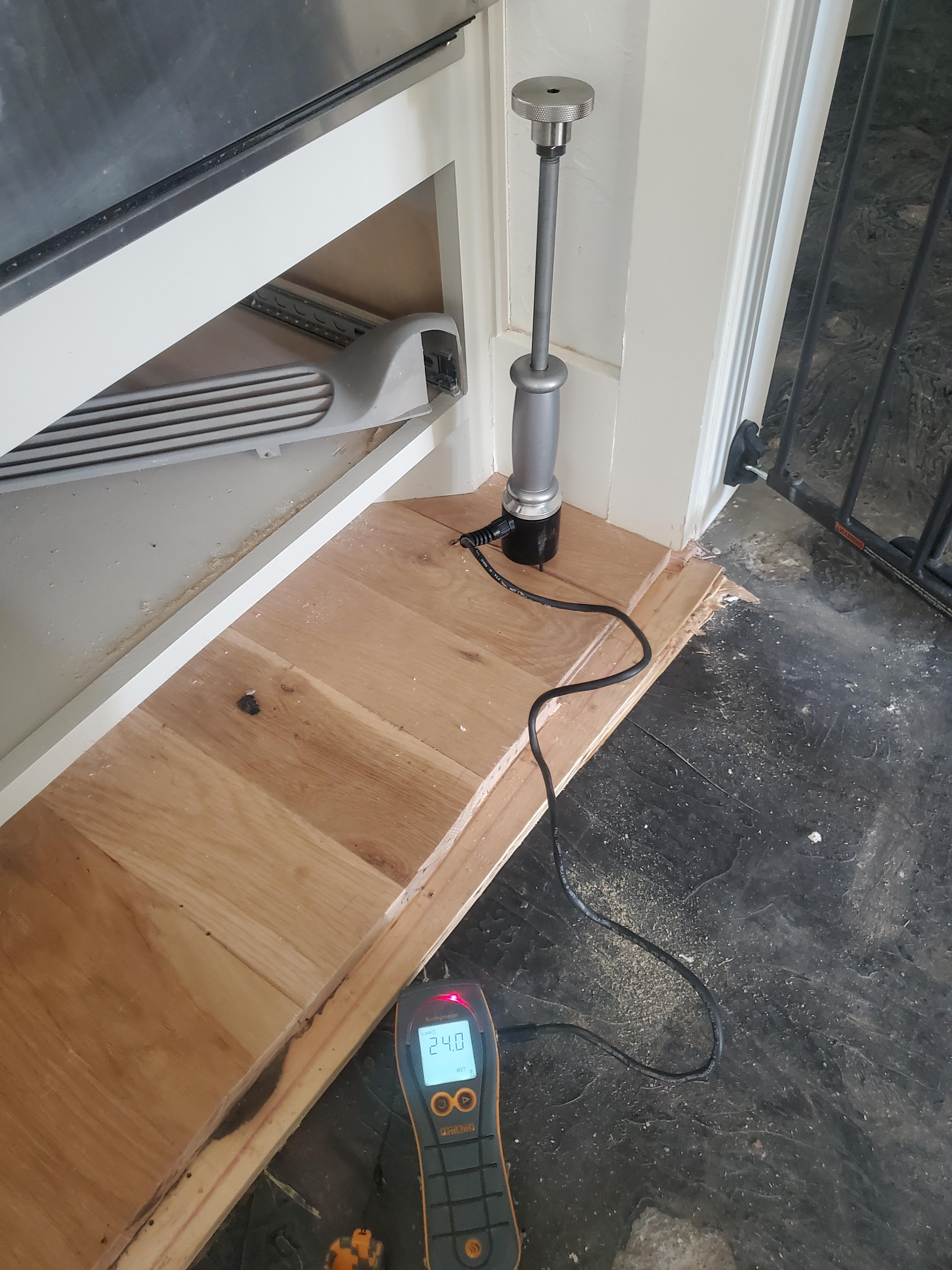 Moisture meter detecting water damage on subfloor Oklahoma City OK